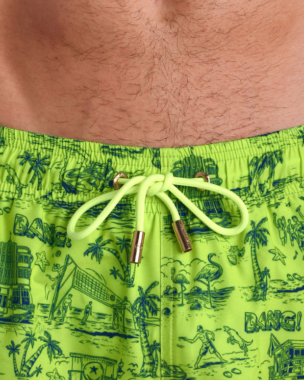 Close-up view of the TOILE DE MIAMI (NEON GREEN/BLUE) men’s summer shorts, showing light green cord with custom branded golden cord ends, and matching custom eyelet trims in gold.