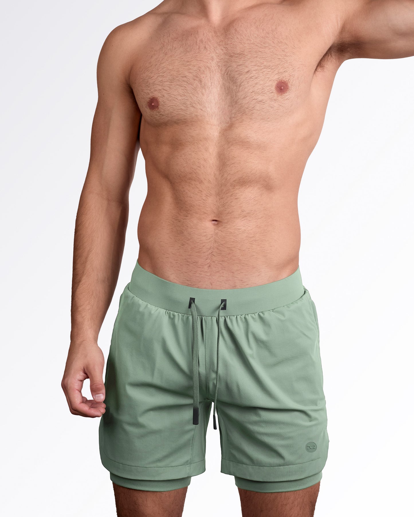 Man wearing lined gym workout shorts in light green from DC2 Miami fitness menswear.