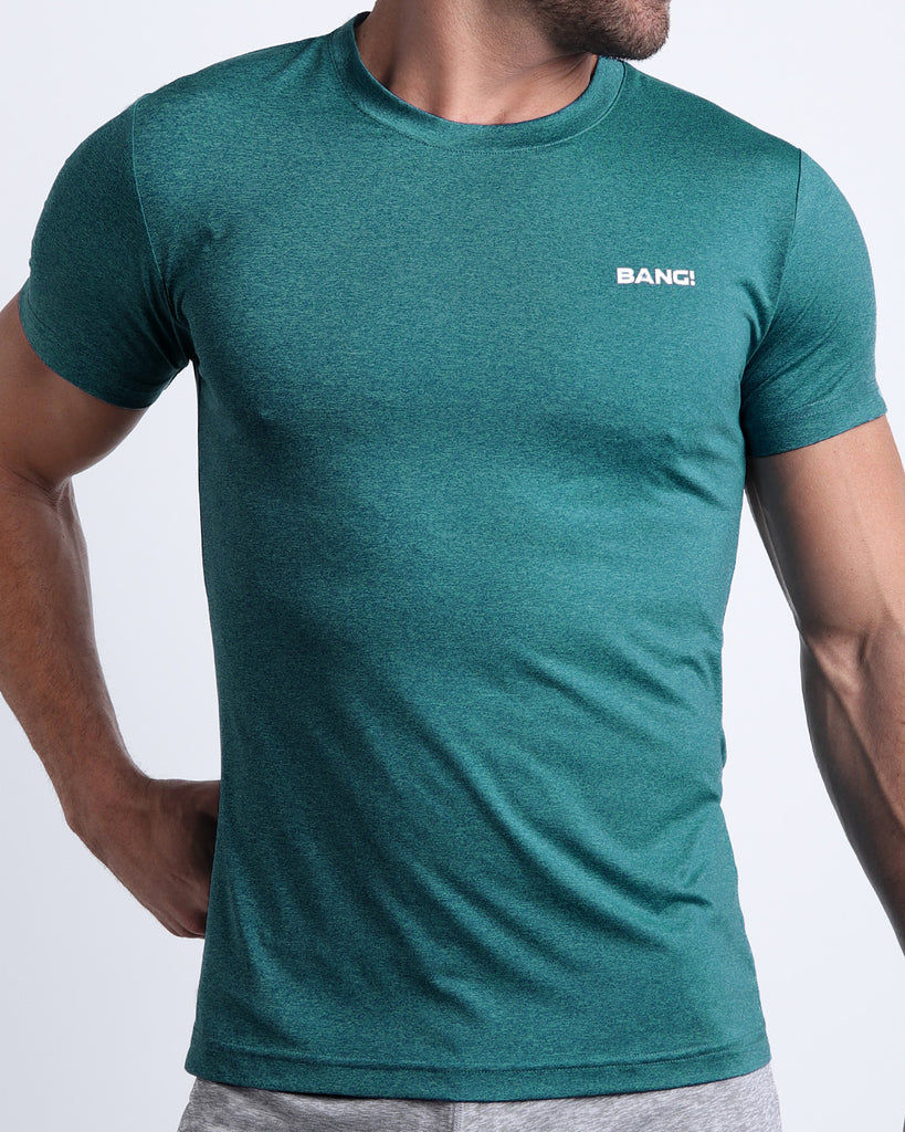 Frontal view of male model wearing the TRAINER TEAL in a solid heathered teal quick-dry workout shirt by the Bang! brand of men's beachwear from Miami.