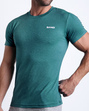 Side view of men’s exercise tee in a blue green color made by BANG! Clothing the official brand of mens beachwear. 