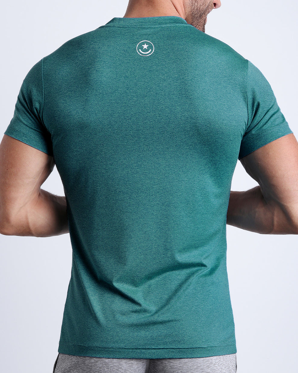 Back view of the TRAINER TEAL men's fitness shirt in a light teal color by BANG! menswear Miami.
