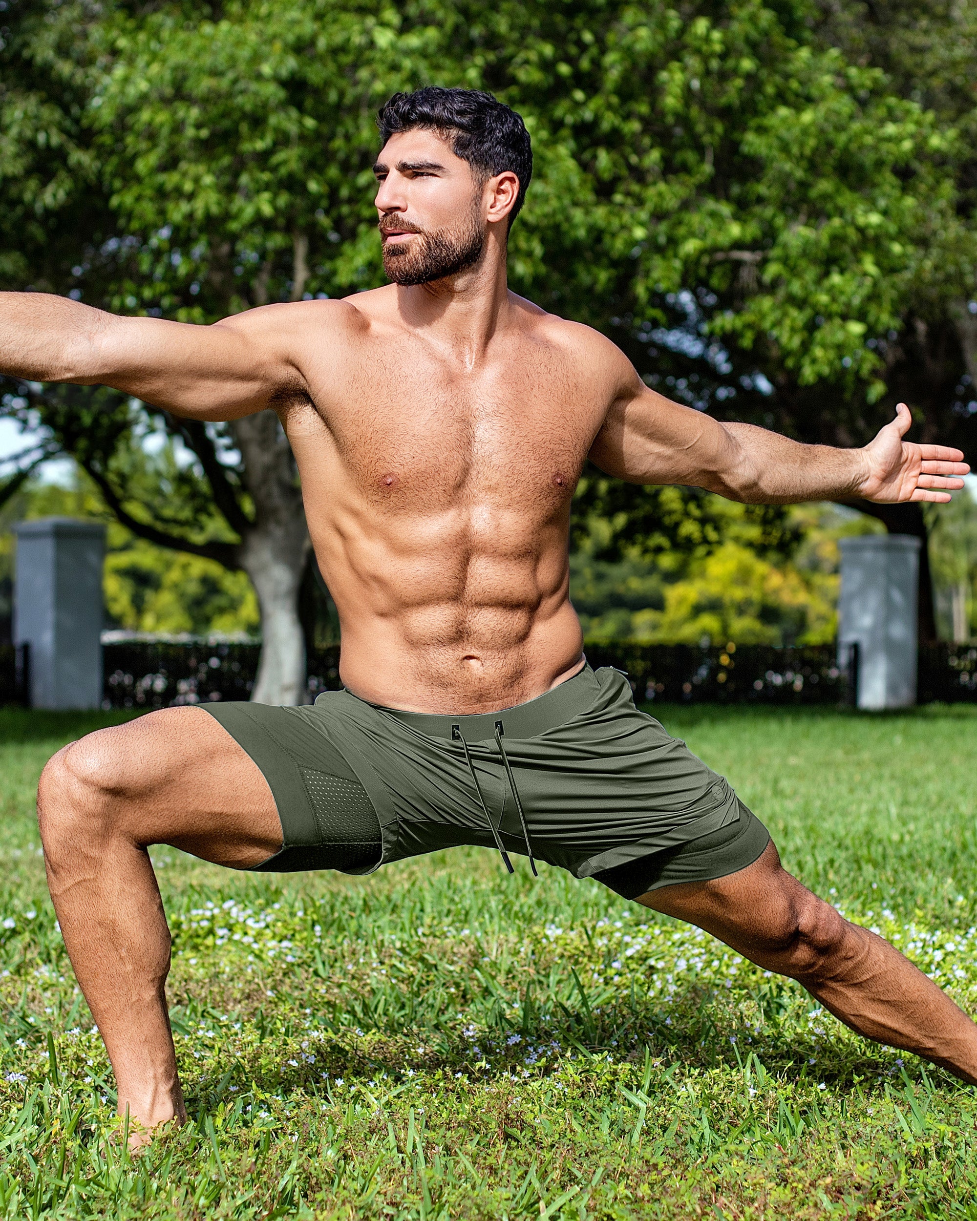 DC2 Miami Tactical Green Endurance 2-in-1 Gym Shorts — model wearing olive men’s training shorts in an outdoor yoga pose.