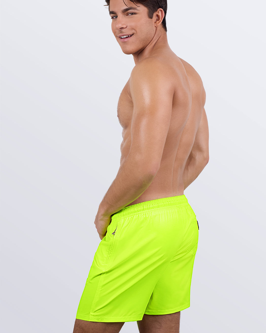 DC2 Ultra Neon Resort Shorts — model smiling in side-back view, highlighting relaxed fit and bold neon color.