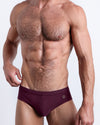 DC2 Spring/Summer 2025 collection — model wearing VERY BERRY swim briefs, featuring a rich berry tone in a sleek low-rise cut.