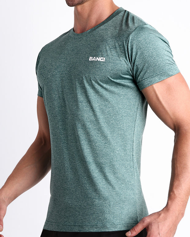 Side view of men’s exercise tee for gym, crossfit, yoga a marbled teal green/blue color with white logo made by BANG! Clothing the official brand of mens beachwear. 