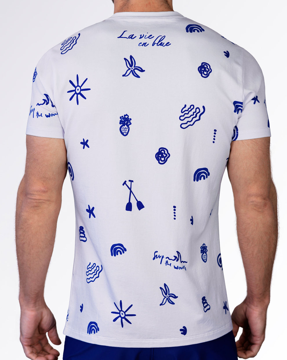 Back view of the Viva La Vida (Blue) graphic tee featuring blue resort-inspired icons and handwritten artwork on white cotton.