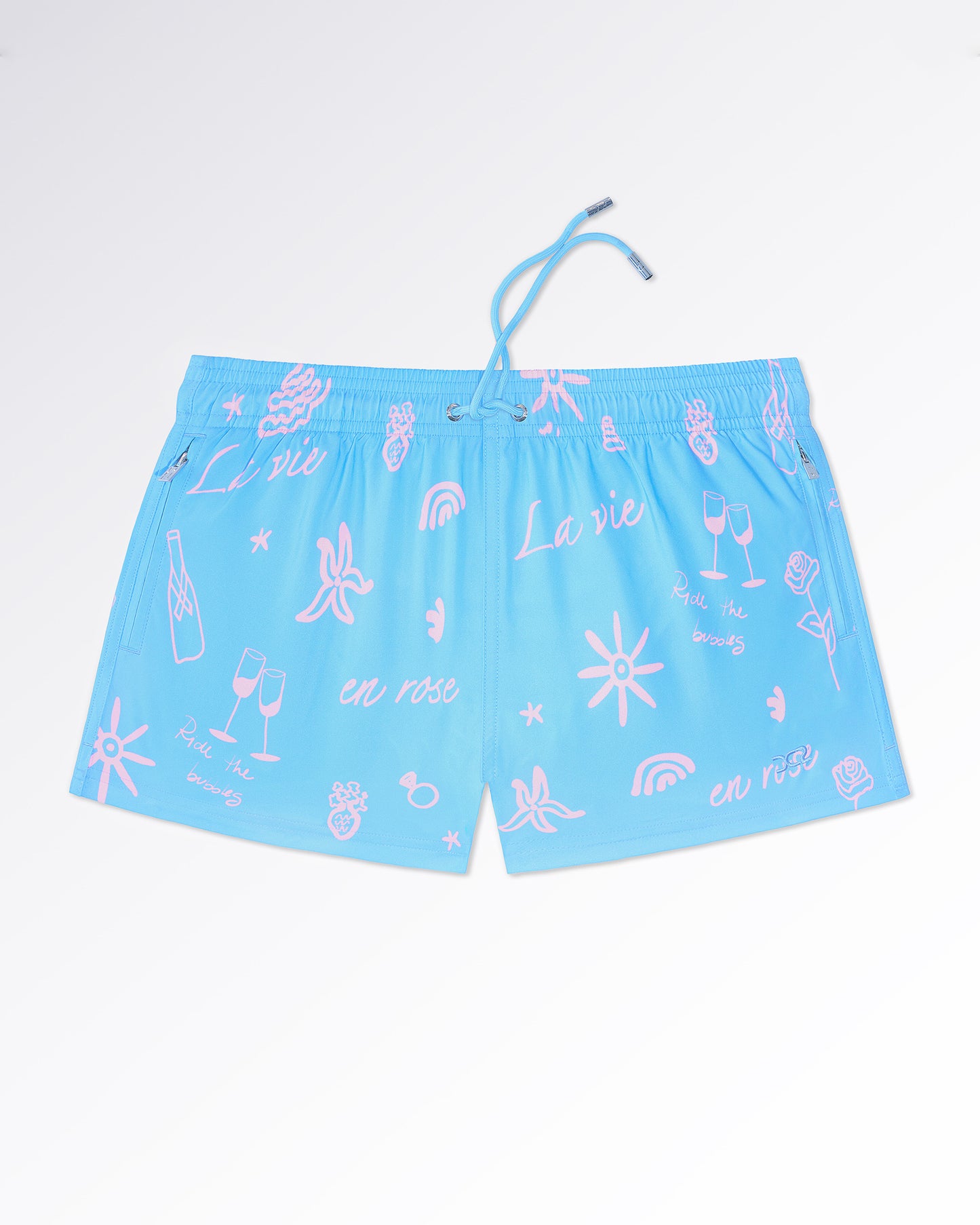 DC2 Viva La Vida (En Rose) Poolside Shorts — flat lay front view highlighting the whimsical pattern of champagne glasses, roses, stars, and script typography across the shorts.