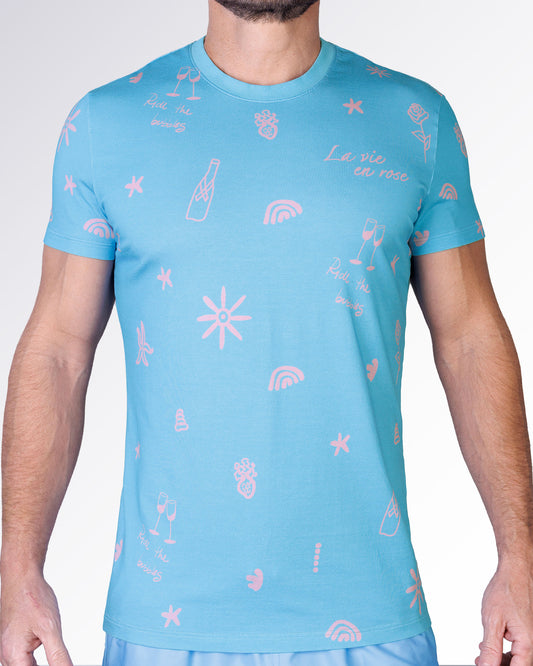 Viva La Vida (En Rose) Cotton Graphic T-Shirt by DC2 Miami featuring a sky-blue base with pink resort-inspired illustrations.