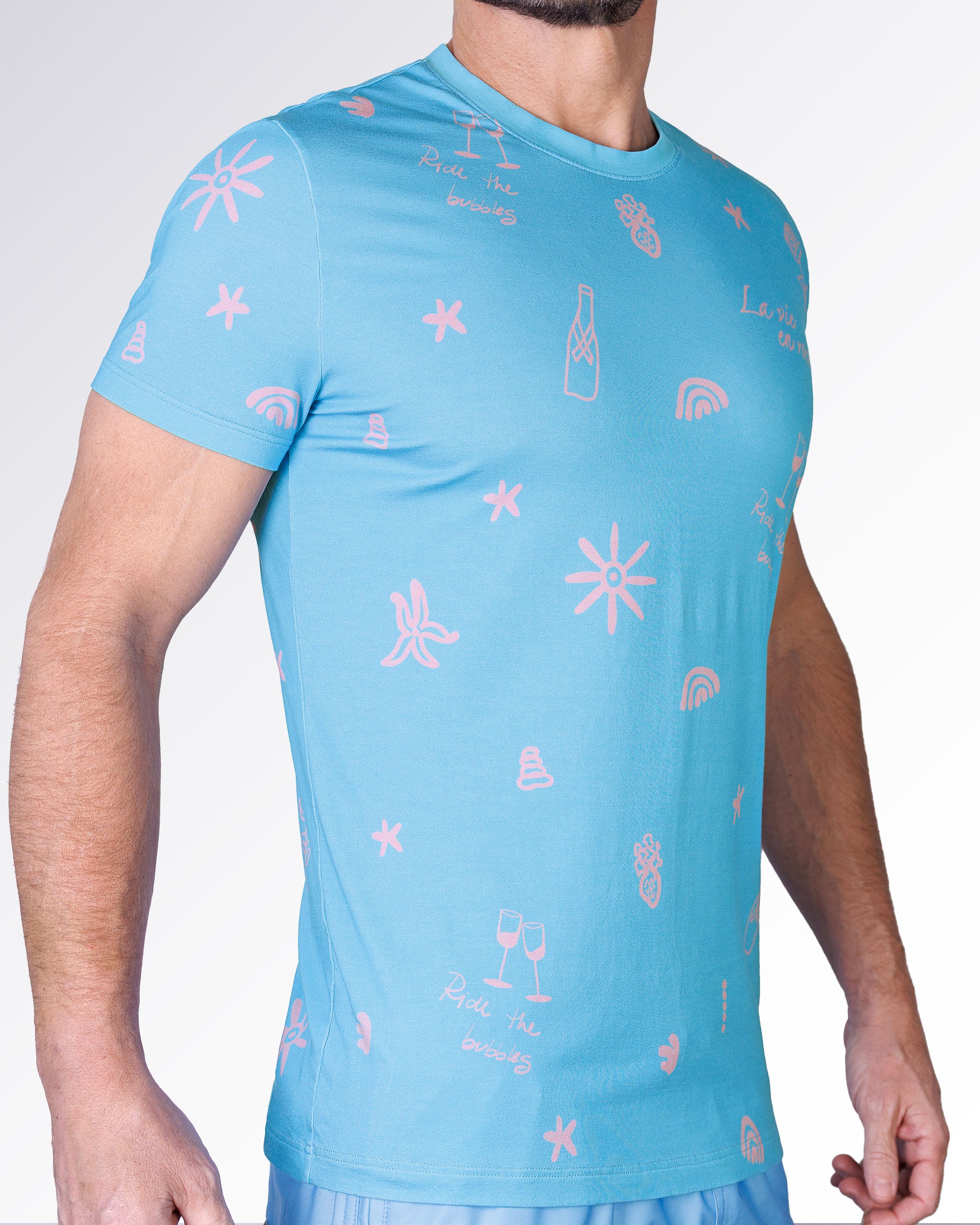 Side view of the Viva La Vida (En Rose) Cotton Graphic T-Shirt by DC2 Miami with pink doodle-style graphics on blue cotton.