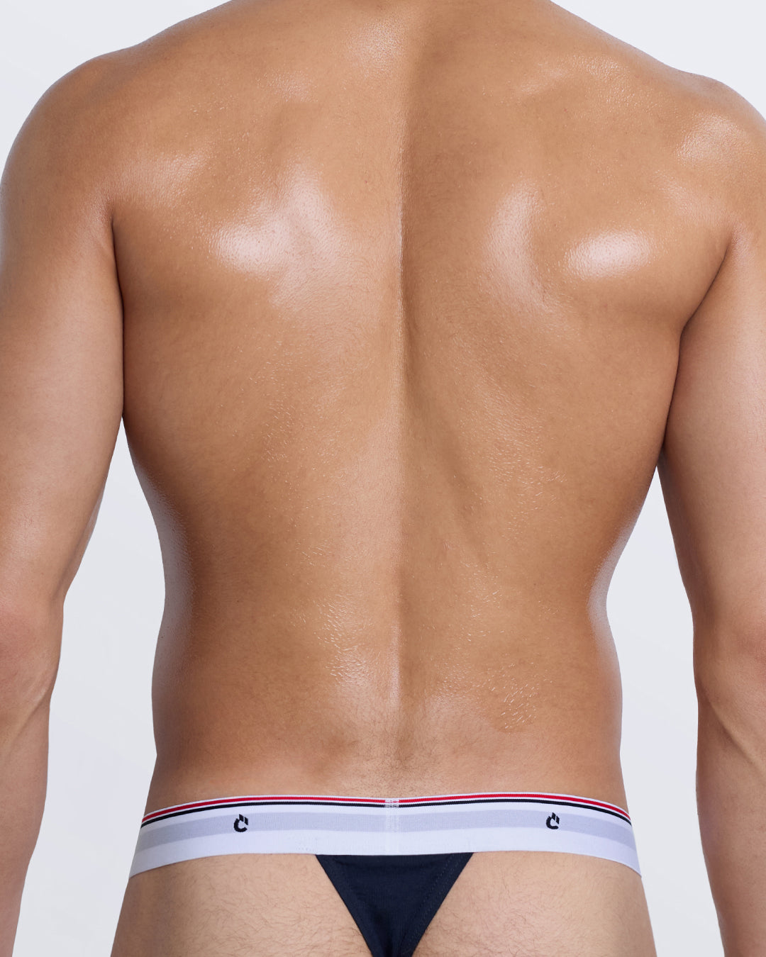 DC2 Modal Thong — back view on model, showing minimal thong coverage and tri-striped elastic waistband.