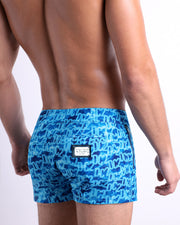 Side view of the WET men’s summer Beach Shorts, with dual zippered pockets. These shorts with a stylish DC2 logo monogram motif made by DC2, a men’s beachwear brand from Miami.