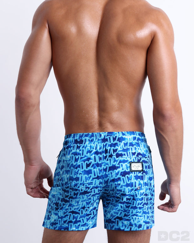 Back view of the WET beach Resort Shorts featuring  a monogram print of the DC2 logo print, complete with a back pocket, designed by DC2. 