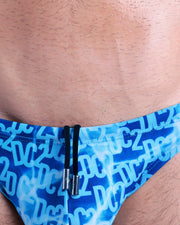 Close-up view of the WET men’s drawstring briefs showing black cord with custom branded metallic silver cord ends, and matching custom eyelet trims in silver.