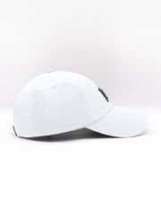 Side view of the WHITE Chillax baseball cap, showcasing its sleek and minimalist design. The cap features a solid white color, durable stitching, and a curved brim, perfect for casual and streetwear styles. Made for comfort and style, this dad hat is ideal for everyday wear, whether at the beach or on the streets.