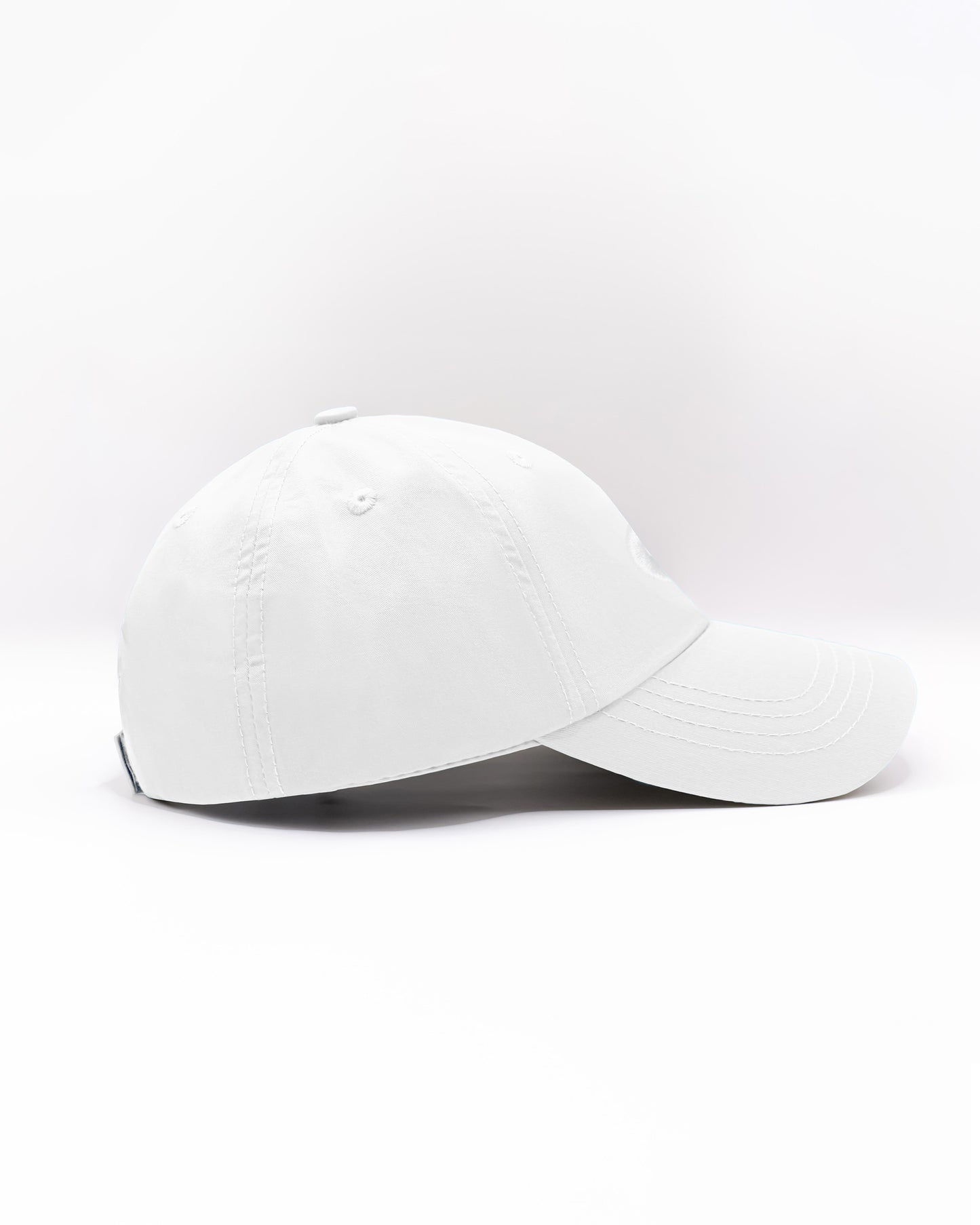 DC2 Resort Cap in White — side view showing the low-profile fit, curved brim, and smooth cotton twill finish.