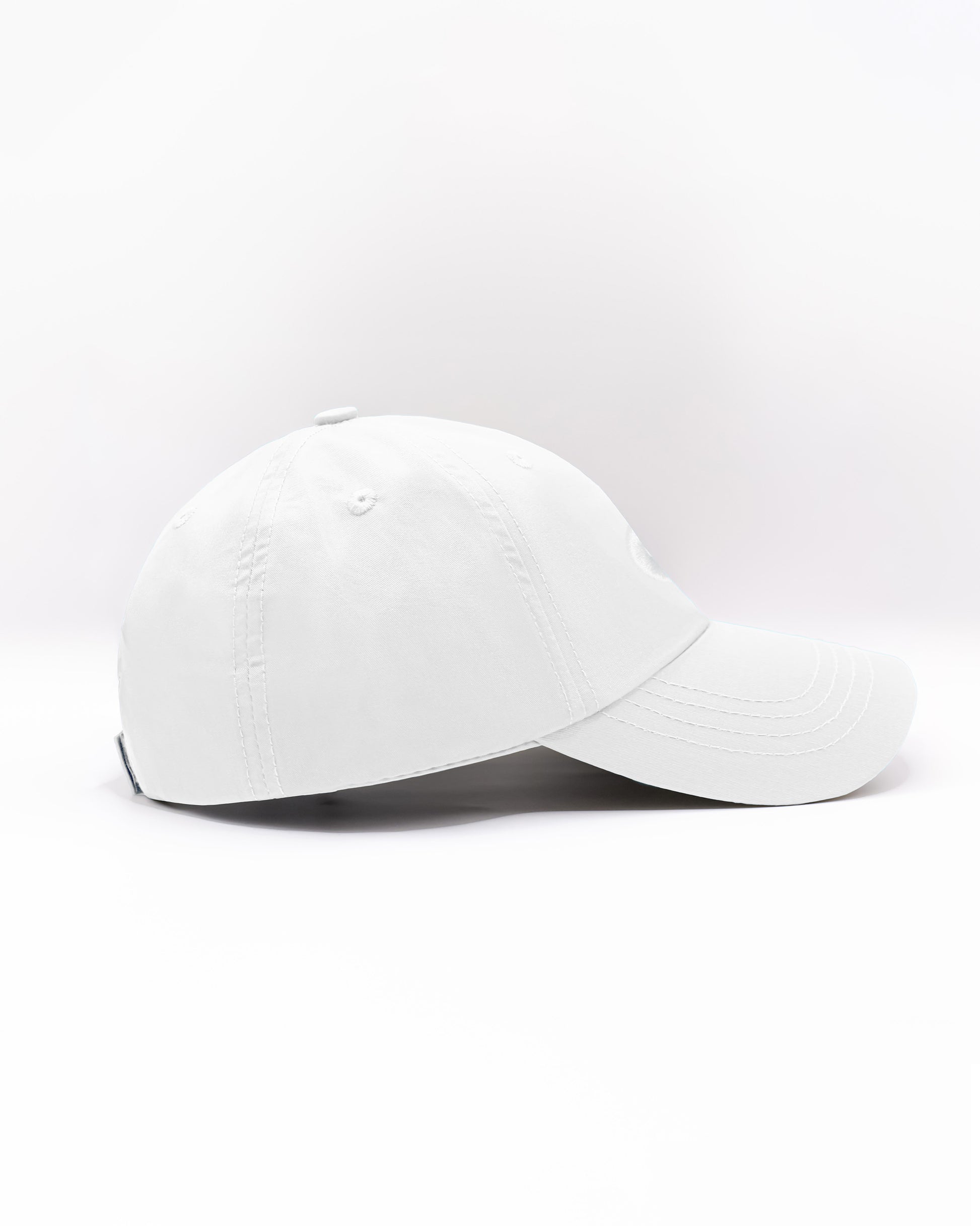 DC2 Resort Cap in White — side view showing the low-profile fit, curved brim, and smooth cotton twill finish.