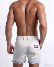 Back view of a model wearing woven twill cotton chino shorts in a white color for men. These premium quality swimwear bottoms are DC2 by BANG! Clothes, a men’s beachwear brand from Miami.
