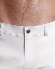 Close up view of cotton fabric chino street shorts with custom engraved front tack button in a silver finish by DC2 men's clothing brand.