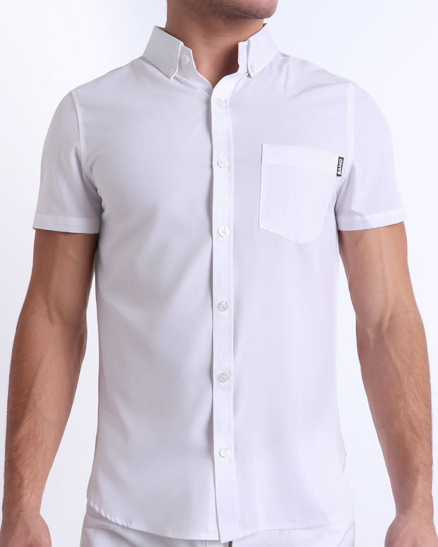 Front view of a sexy male model wearing WHITE PARTY mens short-sleeve stretch shirt in a solid white color by the Bang! brand of men&