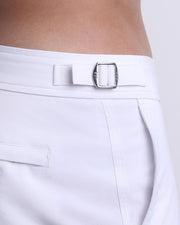 Close-up view of the WHITE PARTY men’s swimwear, showing custom branded silver metal adjustable side buckles.