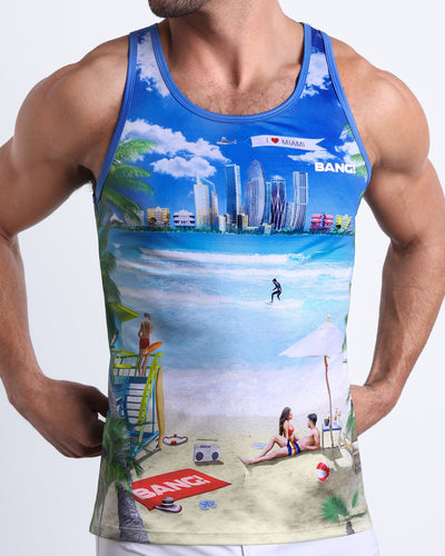 Front view of model wearing the WISH YOU WERE HERE men’s cotton beach tank top featuring Miami Beach skyline art by the Bang! Clothes brand of men's beachwear from Miami.