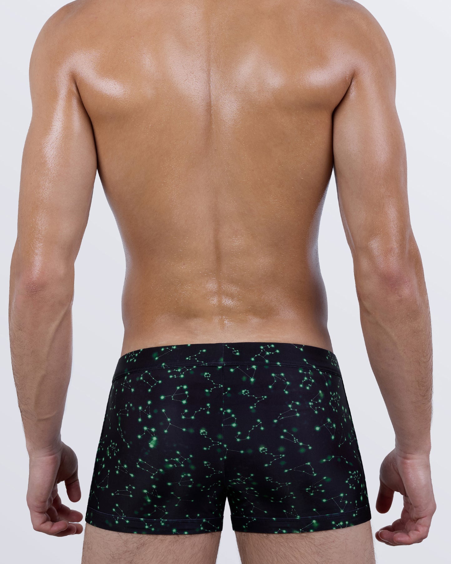 Back view of the WRITTEN IN THE STARS Swim Trunks – galaxy-inspired design with scattered constellations across a sleek black backdrop.