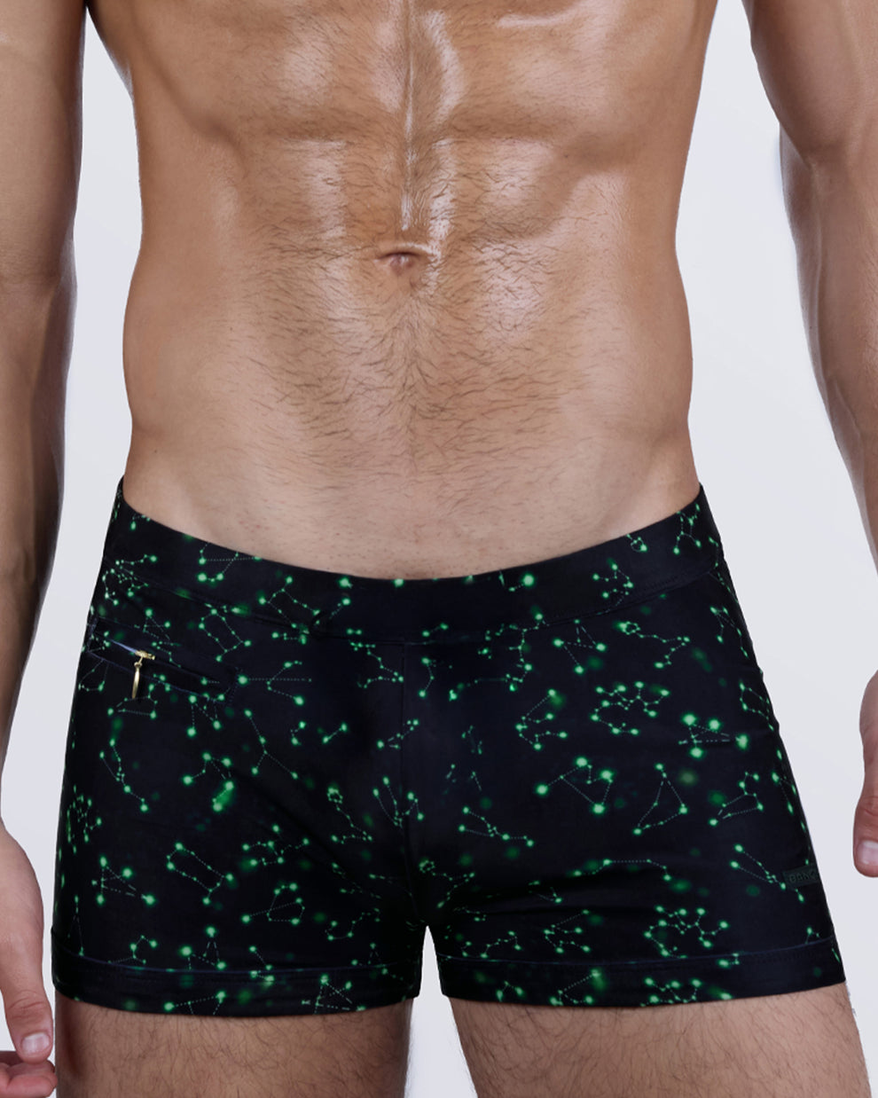 Close-up front of the WRITTEN IN THE STARS Swim Trunks – high-contrast star map effect, adjustable waistband, and discreet side zip pocket.