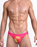 BANG Wuthering Heights (Fucsia) Swim Mini Brief — model wearing pink swim mini brief with neon yellow palm tree print and low-rise tailored fit.
