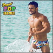 Frontal view of a hot male model in the ocean wearing premium BANG! swim brief made in Miami Florida