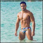 Frontal view of a hot male model in the ocean wearing premium BANG! swim brief made in Miami Florida