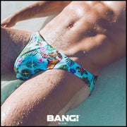 Up close shot of a sexy male model wearing bang clothes premium swim mini brief disco jungle print with light blue and a tiger