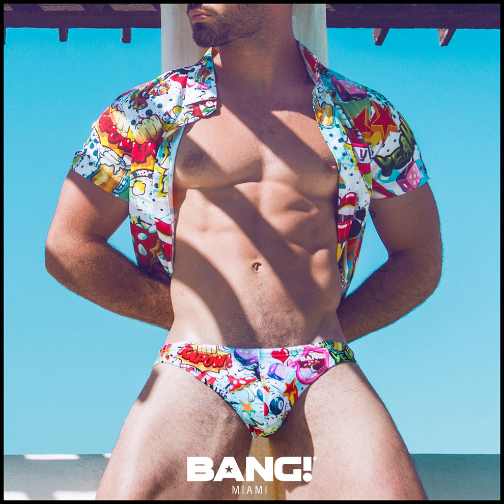 Front view of a sexy male model wearing bang clothes premium swim mini brief yeah yeah print bold colors designer quality fabric