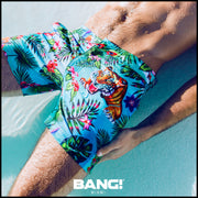 close up view of a sexy male model wearing a bang clothes premium tailored shorts with disco jungle print designer quality fabrics bold colors