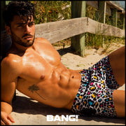 Sexy male model on the beach wearing new BANG Clothes Miami premium 8-bit pop leopard beach shorts upgrade your swimwear gay designer quality
