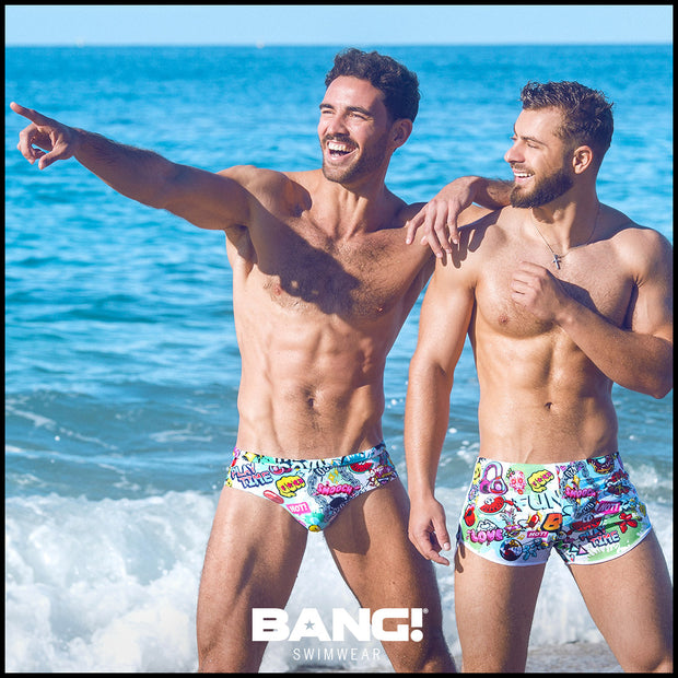 two sexy male models at the beach wearing designer quality premium Bang Miami swim briefs and swim shorts bold colors and prints 2023 gay
