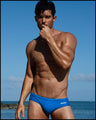 Frontal view of a sexy male model wearing men’s swimsuit in blue by the Bang! Menswear brand from Miami.