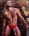 Frontal view of a sexy male model wearing men’s swimsuit in red  by the Bang! Menswear brand from Miami.