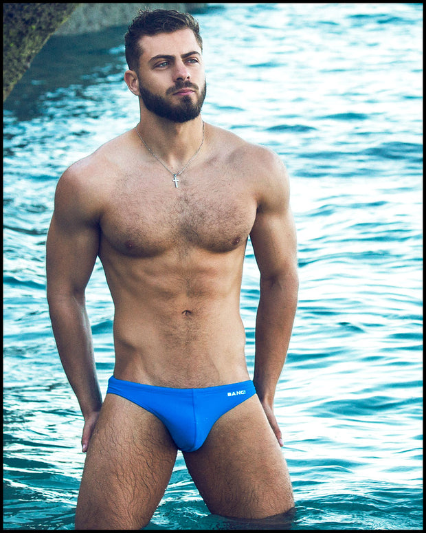 front view of a sexy male model wearing designer quality BANG miami new wave blue swim mini brief summer body 2021