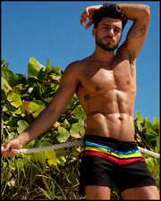 Front view of a sexy male model wearing BANG Miami flex shorts Bionic Stripes series black blue yellow red 2021 lgbtq nation
