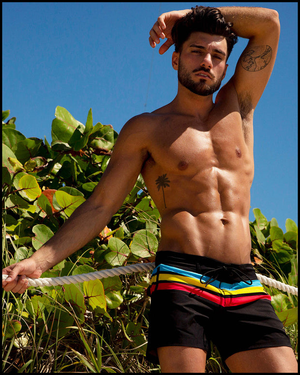 Front view of a sexy male model wearing BANG Miami flex shorts Bionic Stripes series black blue yellow red 2021 lgbtq nation