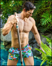 Front view of a sexy male model wearing a BANG Miami show short with perfect fit designer quality colors and bold prints