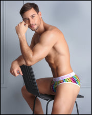 Side view of model sitting down on a chair wearing the GUILTY PLEASURE soft cotton underwear for men by BANG! Clothing the official brand of men's underwear.