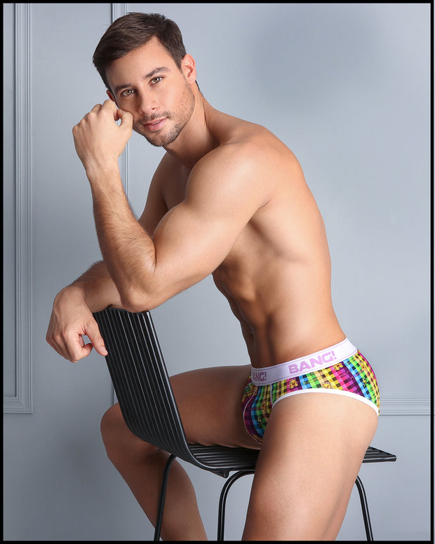 Side view of model sitting down on a chair wearing the GUILTY PLEASURE soft cotton underwear for men by BANG! Clothing the official brand of men&