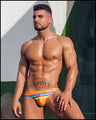 Frontal view of model wearing Stripe A Pose men's swimwear bottom by the Bang! Clothing brand of men's beachwear from Miami.