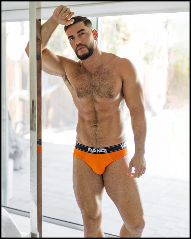 Sexy male model wearing the BLAZE ORANGE soft cotton underwear for men by BANG! Clothing the official brand of men&