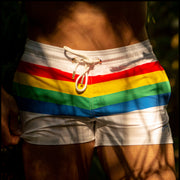 Male model wearing the FOUREVER STRIPES VOL 2 men's beach shorts by the Bang! Clothes brand of men's swimwear from Miami.
