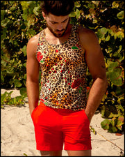 View of model wearing the CATS N'ROSES men’s beach tank top in cotton with leopard print in brown tones with red roses with red color tailored shorts by the Bang! menswear brand.