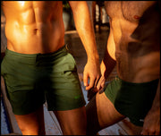 View of ALPHA GREEN men’s swimsuit shorts in army green made by Miami-based Bang Clothing of men's beachwear