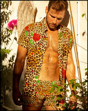 View of a sexy model wearing the CATS N'ROSES men’s beach shorts with matching stretch shirt featuring leopard print in brown tones with red roses by the Bang! menswear brand from Miami.