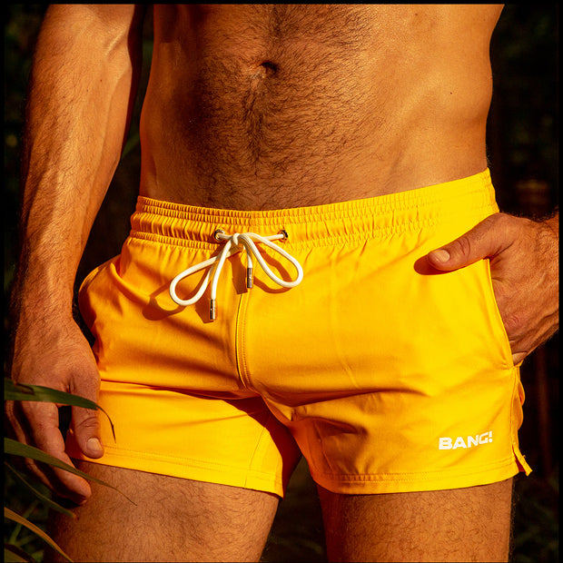 View of the RADIANT YELLOW beach trunks for men by BANG! menswear Miami in sunny yellow color.